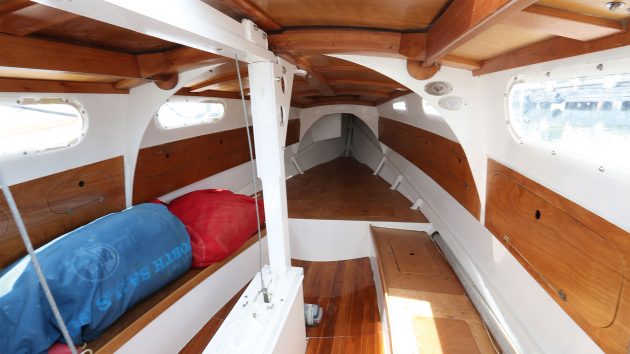 Interior of the Yachting World Diamond cabin, with to benches either side and small windows.